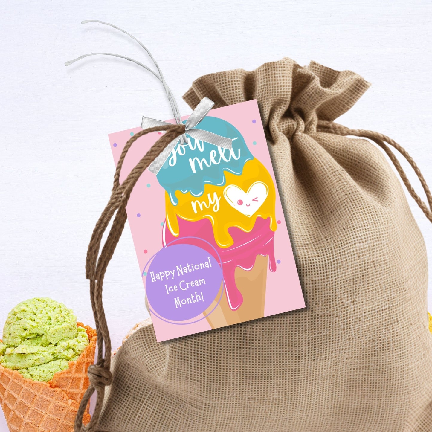A set of colorful gift tags featuring an ice cream cone with scoops in blue, yellow, and pink, and a heart with a smiling face. The tags read "You Melt My Heart" and include a customizable message for National Ice Cream Month.
