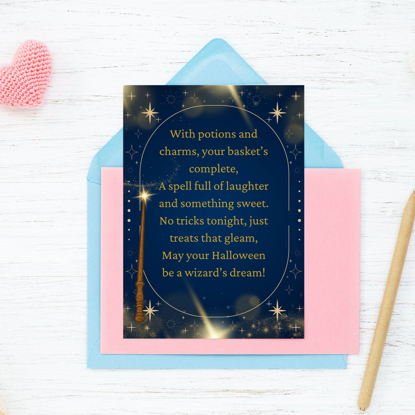Halloween-themed card with a blue and pink envelope on a white wooden surface.