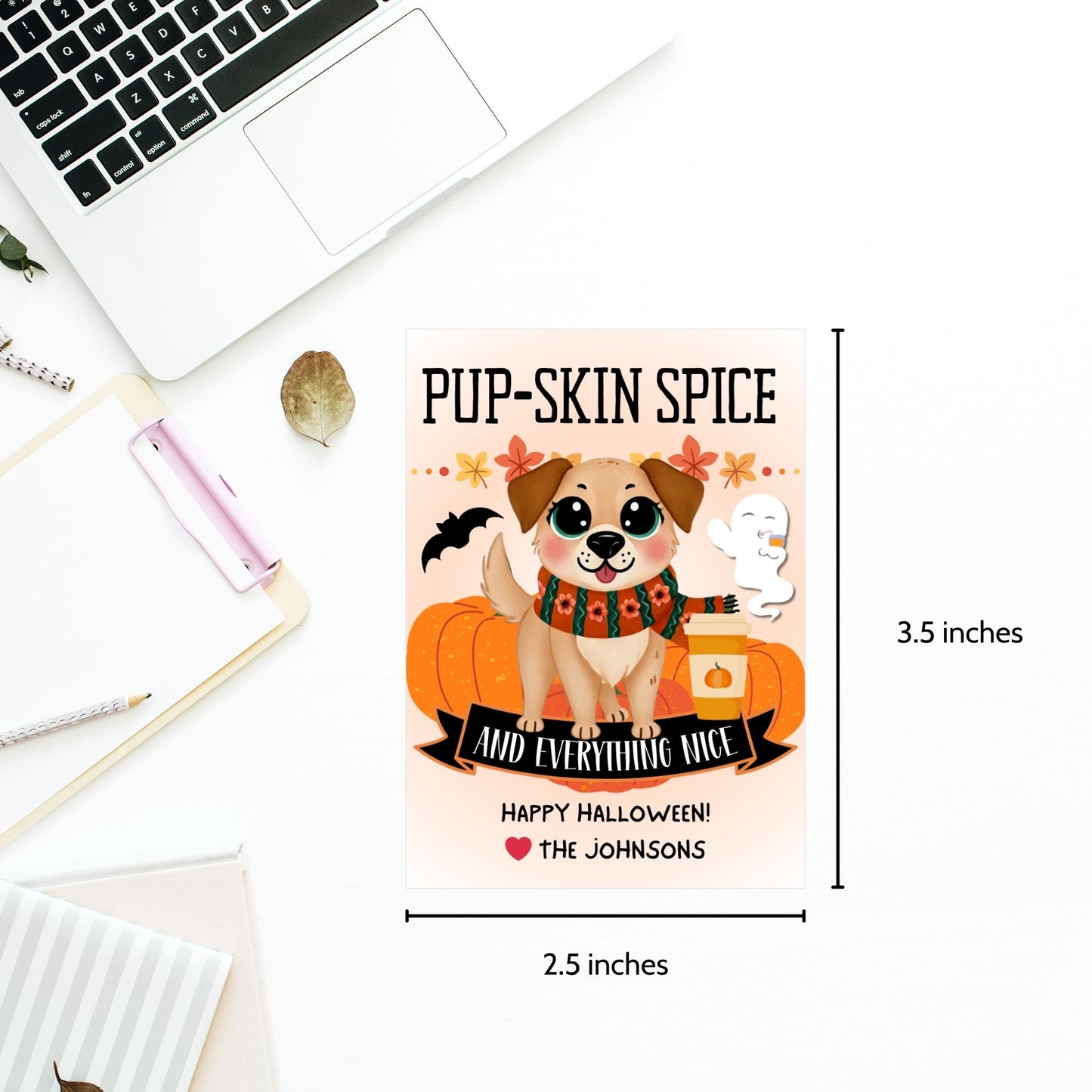 Cute Halloween-themed gift tags featuring a dog with a pumpkin spice latte, surrounded by pumpkins, ghosts, and bats. The tags have the message "Pup-Skin Spice and Everything Nice" and are 2.5 x 3.5 inches, laid out 8 per sheet on an 8.5 x 11-inch page. Includes a printable PDF and a link to an editable Canva template.