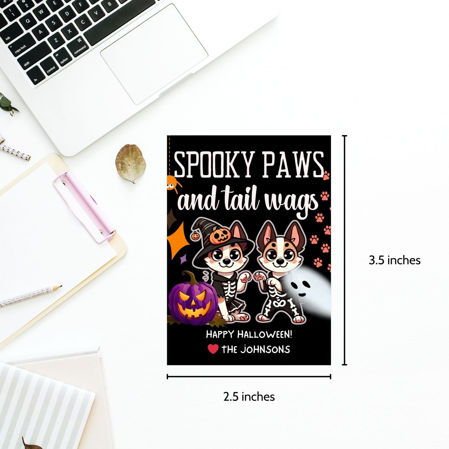 Dog-themed printable Halloween gift tags featuring two dogs in skeleton costumes and pumpkins with the message "Spooky Paws and Tail Wags!" Tags are 2.5 x 3.5 inches, laid out 8 per sheet on an 8.5 x 11-inch page. Includes a printable PDF and a PDF with a link to an editable Canva template.