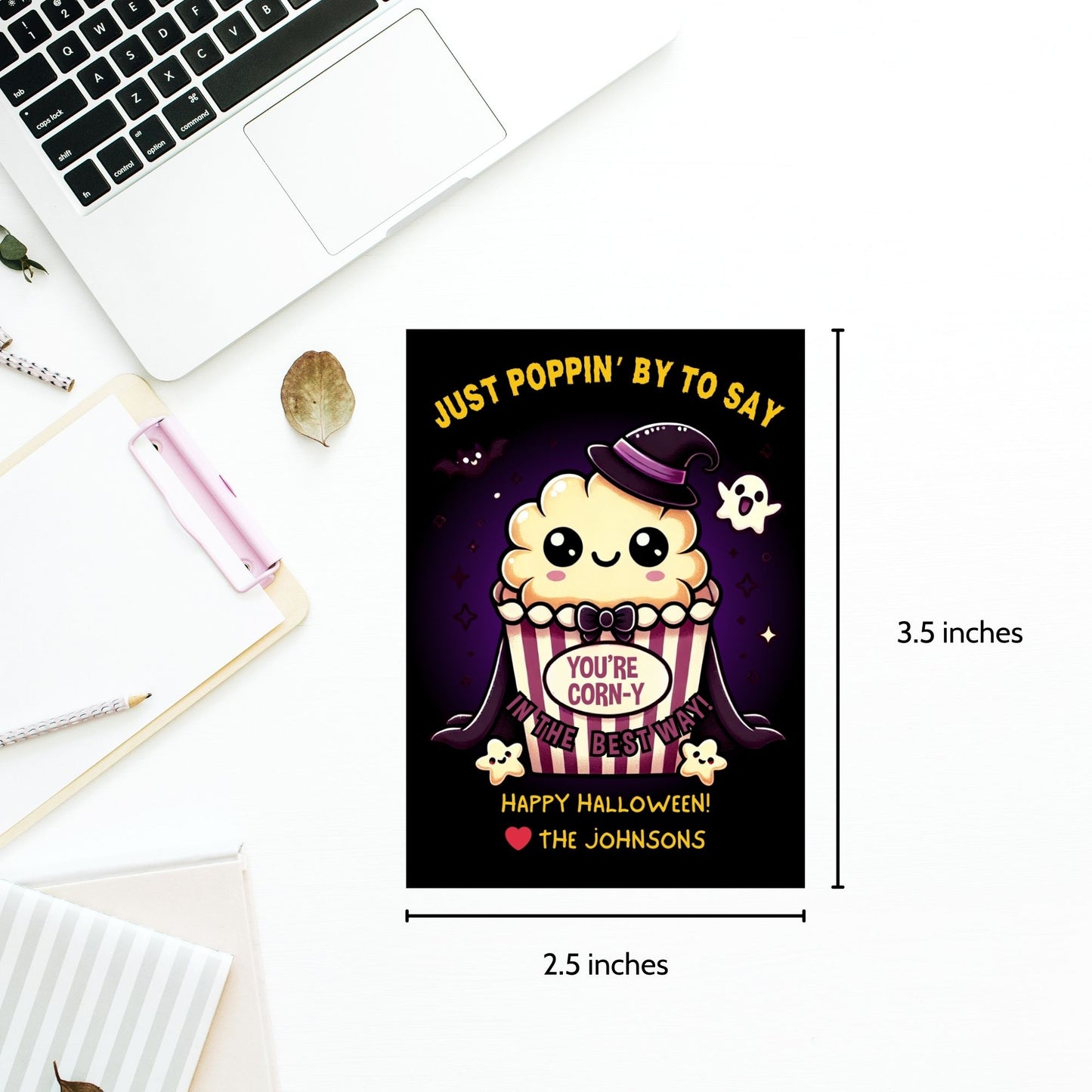 Halloween-themed printable gift tags with the message "Just Poppin' By to Say You're Corn-y in the Best Way" featuring a cute popcorn character dressed in Halloween attire. Tags are 2.5 x 3.5 inches, laid out 8 per sheet on a standard 8.5 x 11-inch page. Includes a printable PDF and a PDF with a link to an editable Canva template.