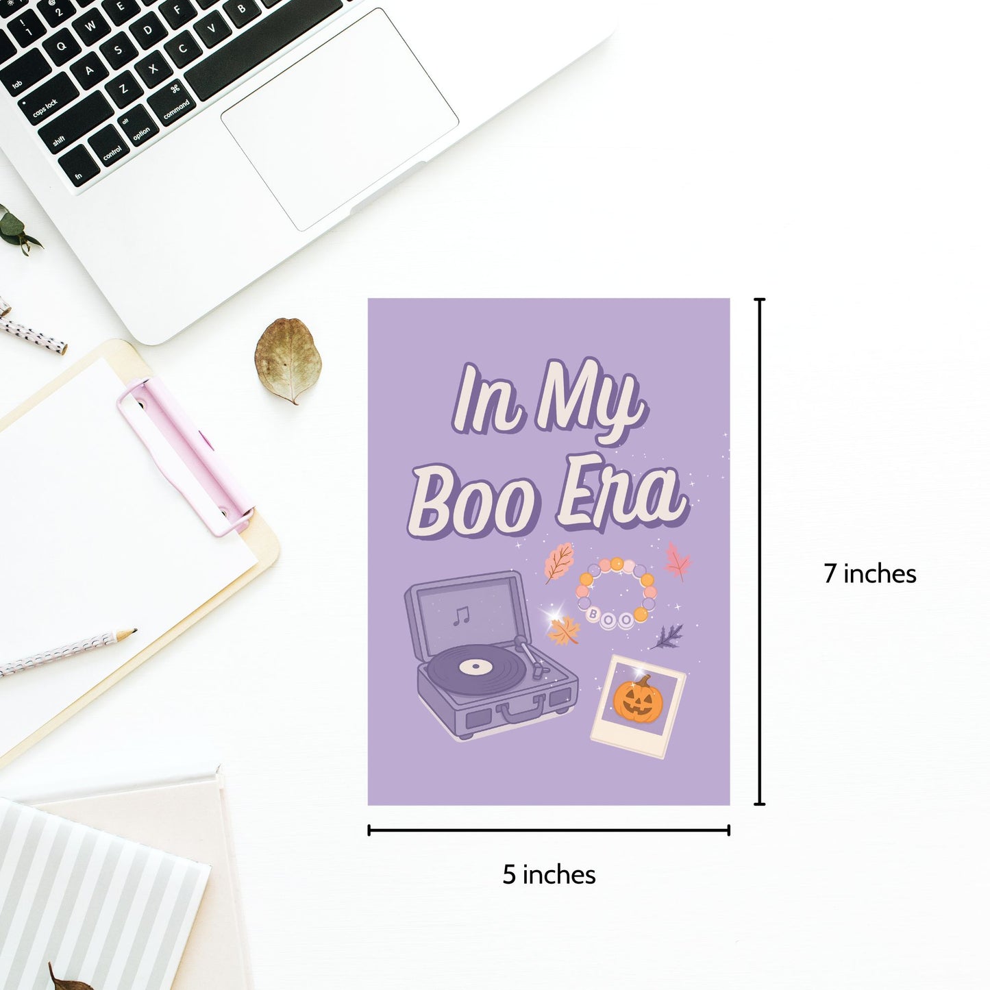 Purple card with 'In My Boo Era' text and record player illustration on a desk with laptop and stationery.