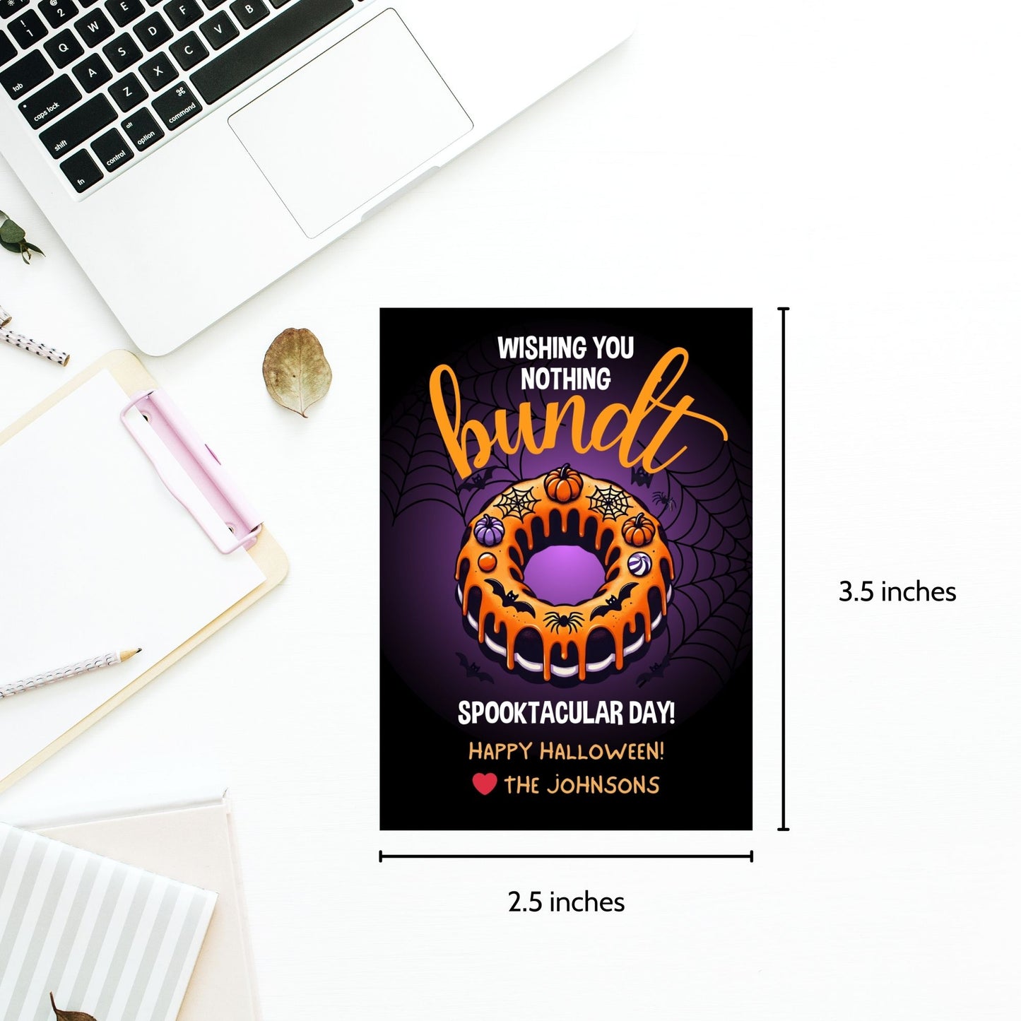Halloween gift tag featuring a bundt cake decorated with pumpkins and spiderwebs, with the message 'Wishing You Nothing Bundt a Spooktacular Day!'