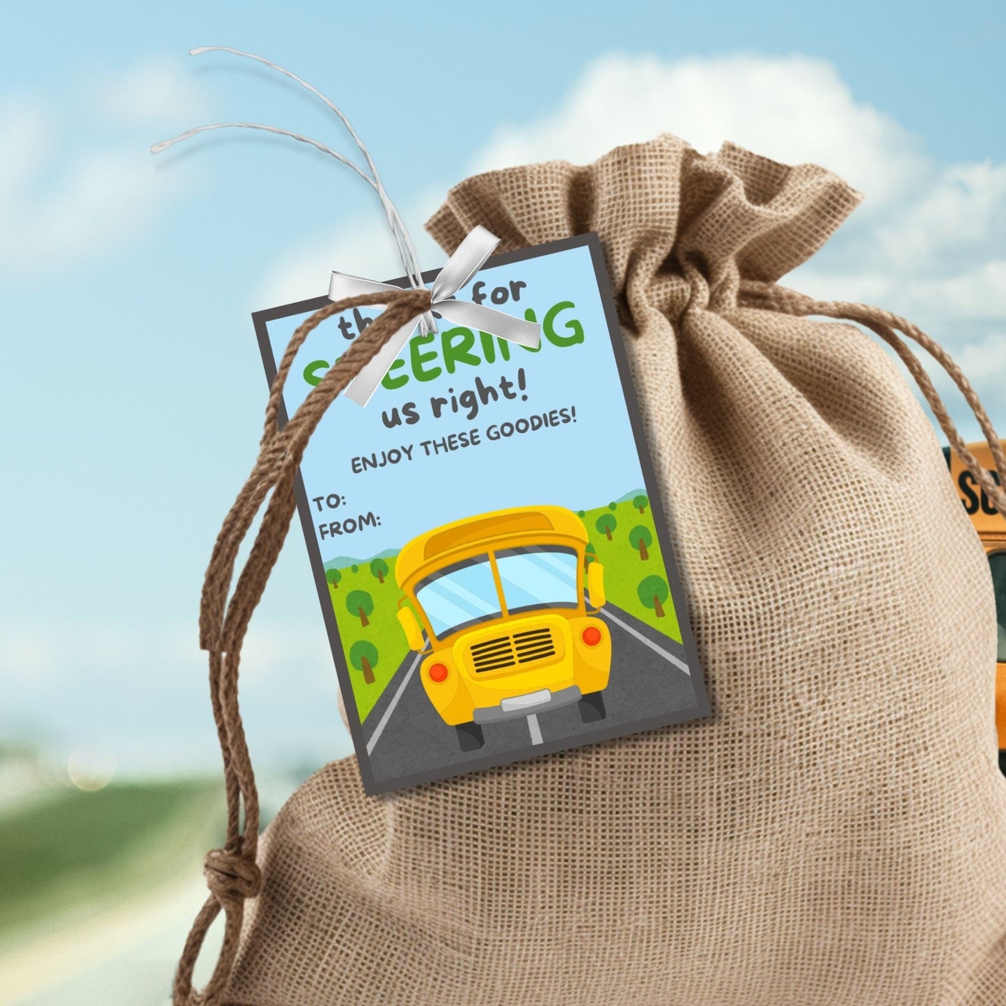 Printable bus driver appreciation tags featuring a school bus, trees, road, and the words Thanks for steering us right. Space for a personal note included.