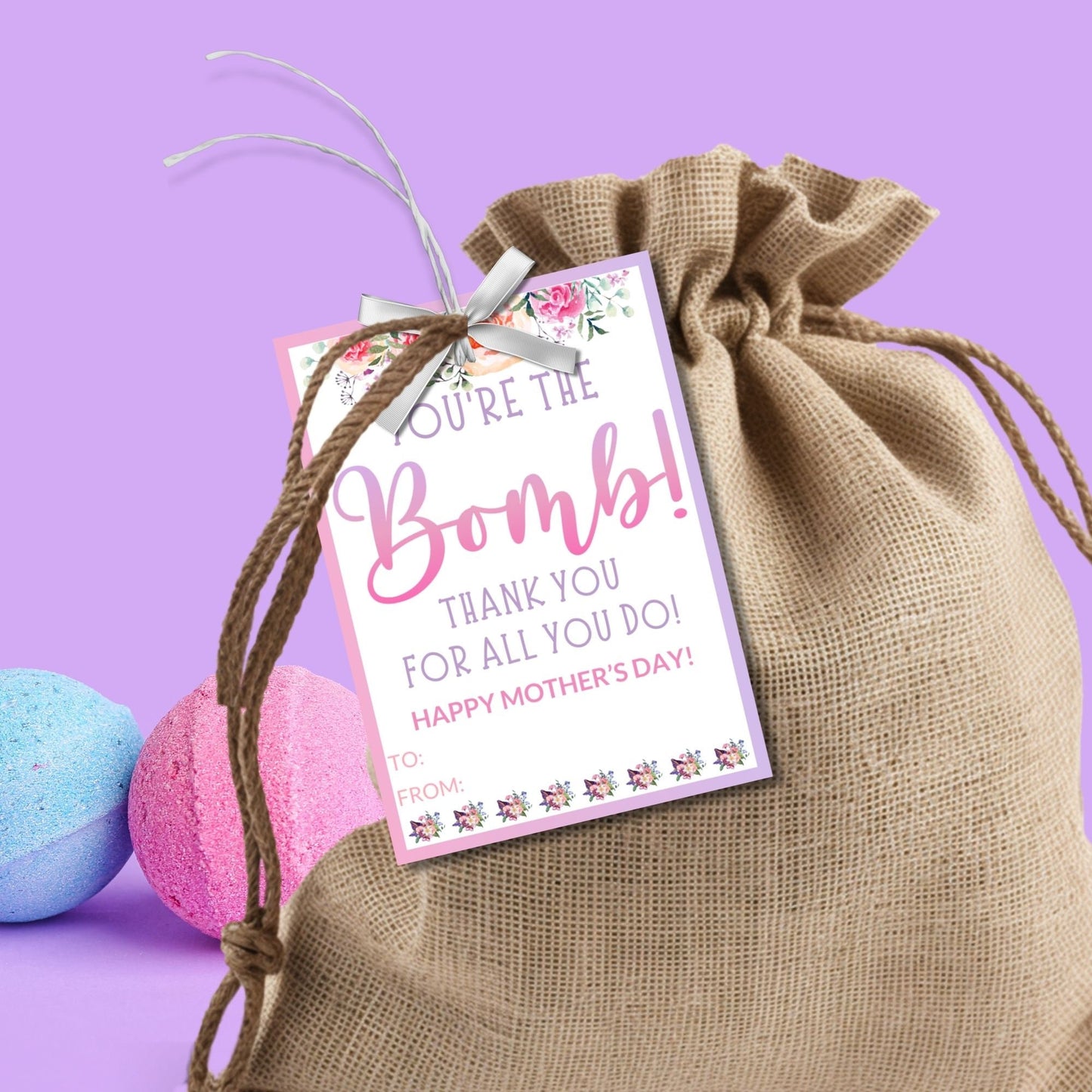 Gift tags for bath bombs or chocolate bombs with the message Youre the Bomb! Thank you for all you do! Happy Mother's Day surrounded by floral accents on a pink and white background.