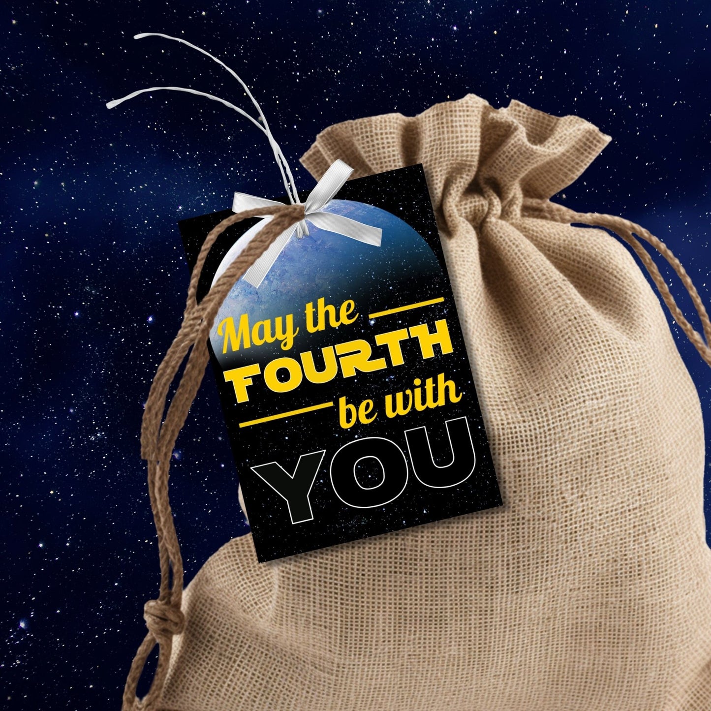 Starry space background with a vibrant Earth-like planet, featuring May the FOURTH be with YOU text for printing customizable gift tags.