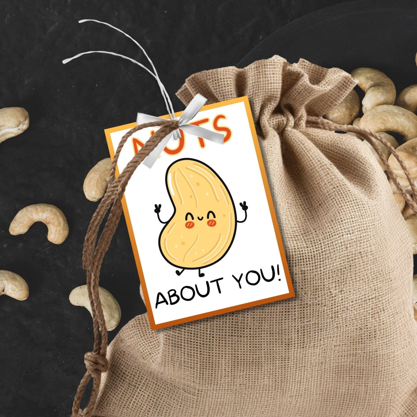 Nuts About You! appreciation gift tags featuring a cute cartoon cashew with arms, eyes, and a smile, bordered by an orange frame on a white background, ready for personalization.