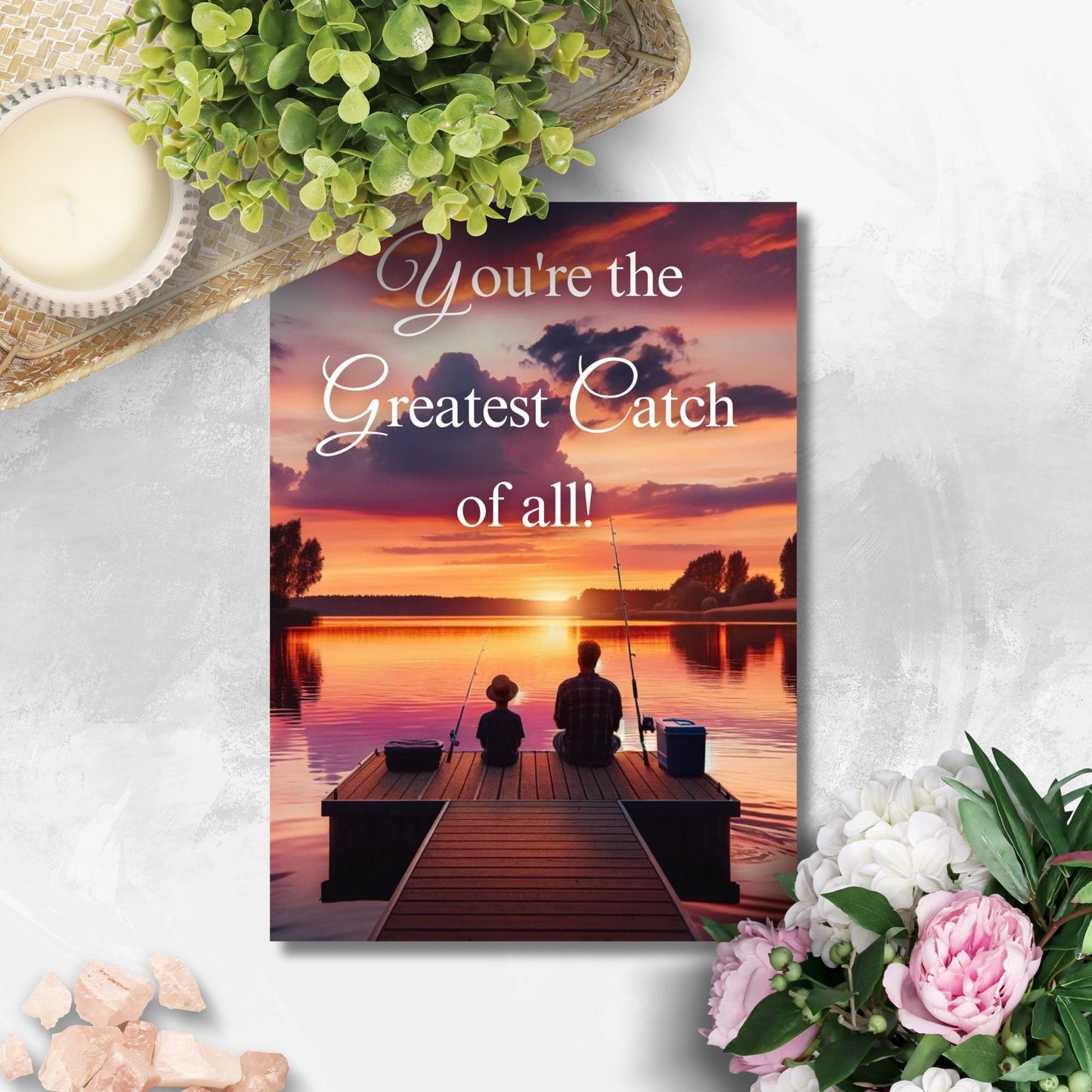 Father's Day printable card with the message Youre the Greatest Catch of all! over a serene sunset fishing scene, sized 5x7 inches, laid out on an 8.5x11 inch sheet, featuring two cards for easy home printing.