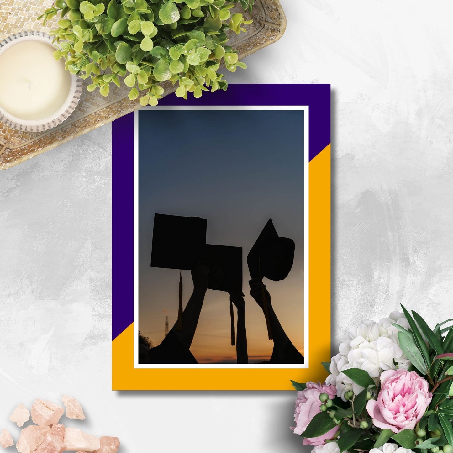 Dynamic double-sided graduation party invitation featuring graduates with diplomas at sunset on the front, and party details over a vibrant purple and yellow background on the back.