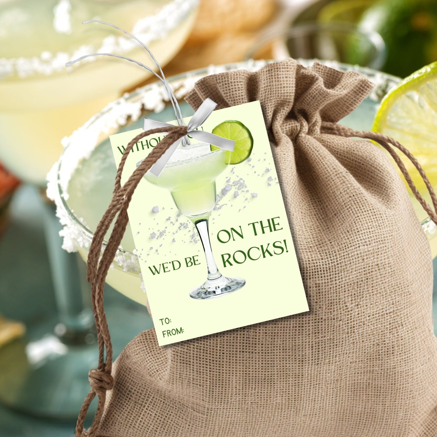 A sheet of light green gift tags with the text Without you, wed be on the rocks! in elegant green letters, featuring a margarita glass with a lime wedge and a customizable message that says Thank you for a great year! ❤️ Taylor.