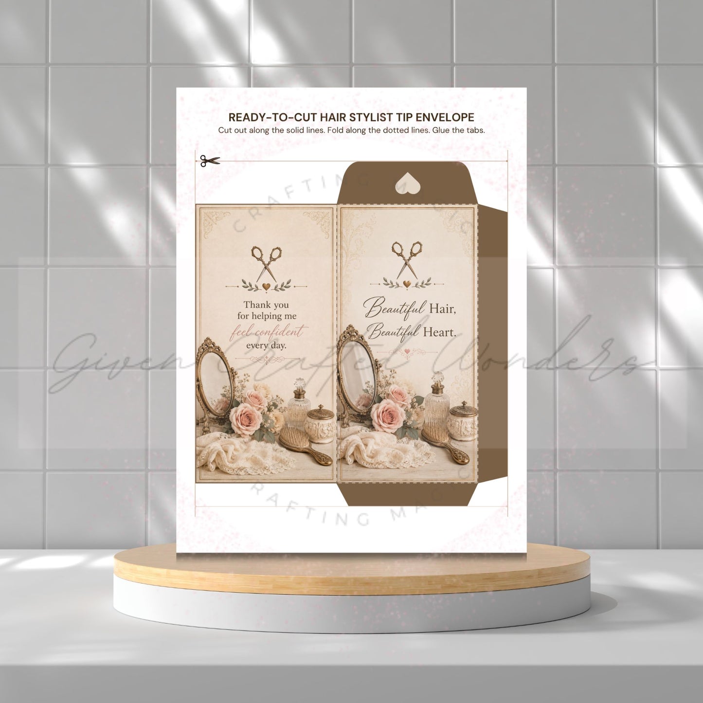 A printable hair stylist tip envelope card shown on a white background with a gray tiled wall behind it, displayed on a round wooden-and-white pedestal. The card includes decorative vintage styling imagery and text such as 'READY-TO-CUT HAIR STYLIST TIP ENVELOPE' and 'Thank you for helping me be a Beautiful Hair, Beautiful Heart.