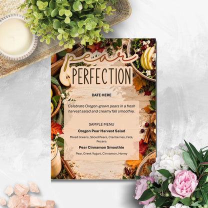 A printed event menu card titled 'Pear Perfection' styled on a light stone surface with greenery, a candle, and flowers around it. The menu features a rustic autumn harvest design with pears, cinnamon, and seasonal illustrations, plus sample menu items including pear harvest salad and pear cinnamon smoothie.
