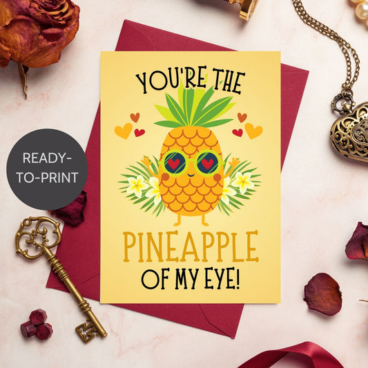 Printable Valentine’s Day Greeting Card featuring the phrase “You’re the Pineapple of My Eye” with a cheerful pineapple theme. Designed as a 5x7 PDF on an 8.5 x 11 sheet with two cards per page. A fun and tropical Valentine’s card for loved ones.