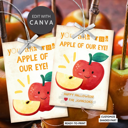 Halloween-themed printable gift tags with the message "You Are the Apple of Our Eye!" featuring a cute apple character perfect for caramel apple gifts. Tags are 2.5 x 3.5 inches, laid out 8 per sheet on a standard 8.5 x 11-inch page. Includes a printable PDF and a PDF with a link to an editable Canva template.