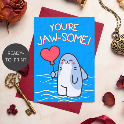 Printable Valentine’s Day Greeting Card featuring the phrase “You’re Jawsome” with a shark theme. Designed as a 5x7 PDF on an 8.5 x 11 sheet with two cards per page. A fun and unique Valentine’s card for shark lovers.