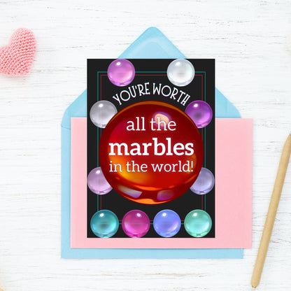 A Squid Game-inspired printable Valentine's Day card featuring a marbles theme. The card has a bold, fun design with the phrase "You're Worth All the Marbles in the World," making it a perfect gift for fans of the show, gamers, and pop culture enthusiasts.
