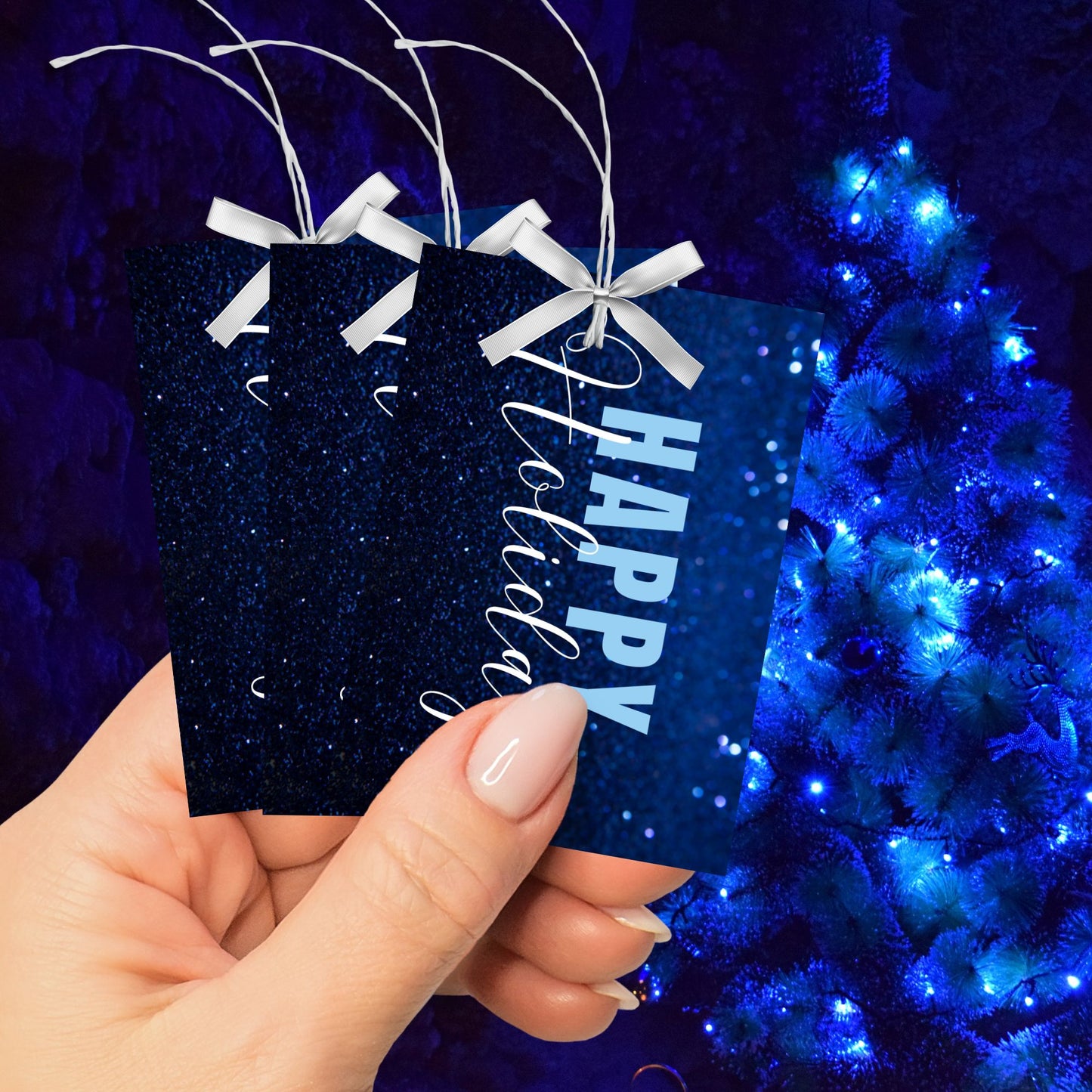 Printable blue Holiday gift tags with a glittery blue background and bold light blue "Happy Holidays" text, sized 2.5 x 3.5 inches, 8 tags per sheet.