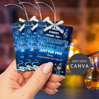 Three blue gift bags with text held by a hand, blurred background with a drink.