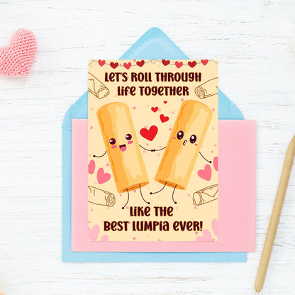 Printable Valentine’s Day card featuring the phrase “Let’s Roll Through Life Together Like the Best Lumpia Ever” with a Filipino Lumpia-inspired design. Designed as a 5x7 PDF on an 8.5 x 11 sheet with two cards per page. A punny and heartfelt Valentine’s card for Filipino food lovers.