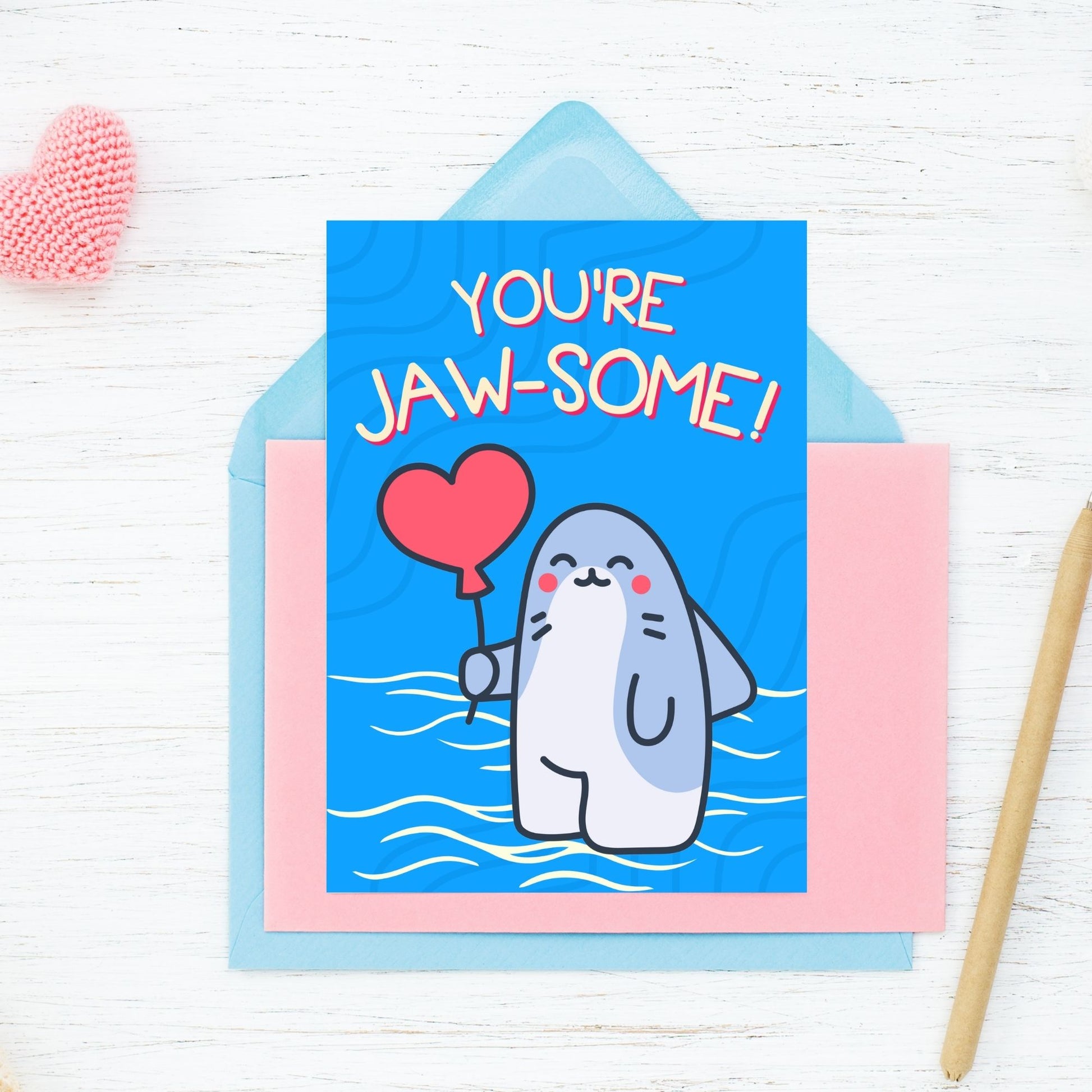 Printable Valentine’s Day Greeting Card featuring the phrase “You’re Jawsome” with a shark theme. Designed as a 5x7 PDF on an 8.5 x 11 sheet with two cards per page. A fun and unique Valentine’s card for shark lovers.