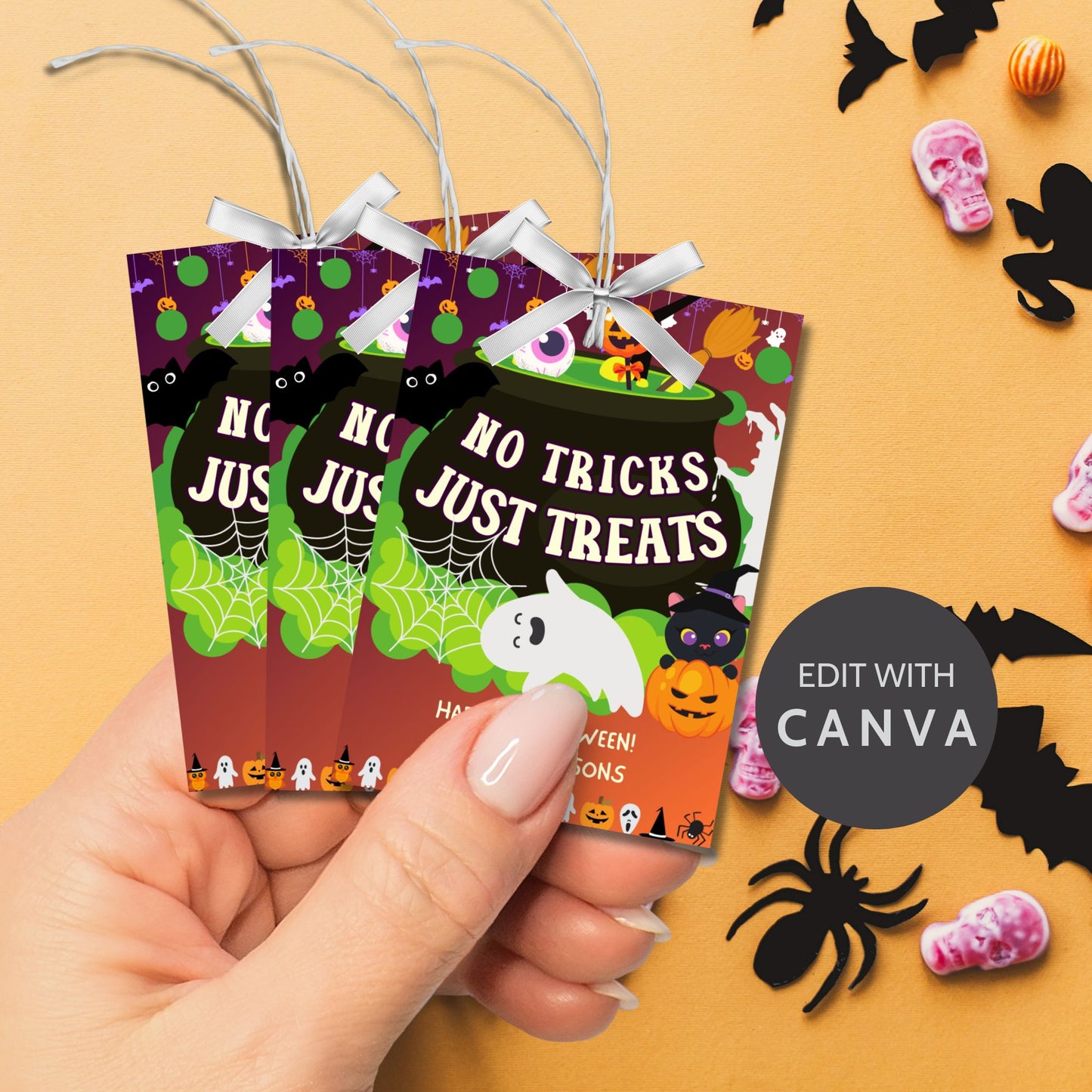 Halloween-themed printable gift tags with the message "No Tricks, Just Treats" featuring colorful cauldrons, ghosts, and pumpkins, perfect for treat gifts. Tags are 2.5 x 3.5 inches, laid out 8 per sheet on a standard 8.5 x 11-inch page. Includes a printable PDF and a PDF with a link to an editable Canva template.