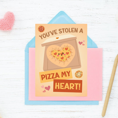 Printable Valentine’s Day Greeting Card featuring the phrase “You’ve Stolen a Pizza My Heart” with a pizza theme. Designed as a 5x7 PDF on an 8.5 x 11 sheet with two cards per page. A fun and punny Valentine’s card for pizza lovers.