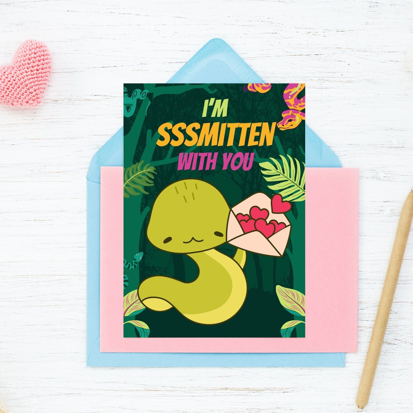 Printable Valentine’s Day Greeting Card featuring the phrase “I'm Sssmitten With You” with a snake theme. Designed as a 5x7 PDF on an 8.5 x 11 sheet with two cards per page. A playful and unique Valentine’s card for snake lovers.