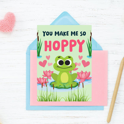 Printable Valentine’s Day Greeting Card featuring the pun “You Make Me So Hoppy.” Designed as a 5x7 PDF on an 8.5 x 11 sheet with two cards per page. A fun and cute Valentine’s card for frog lovers.