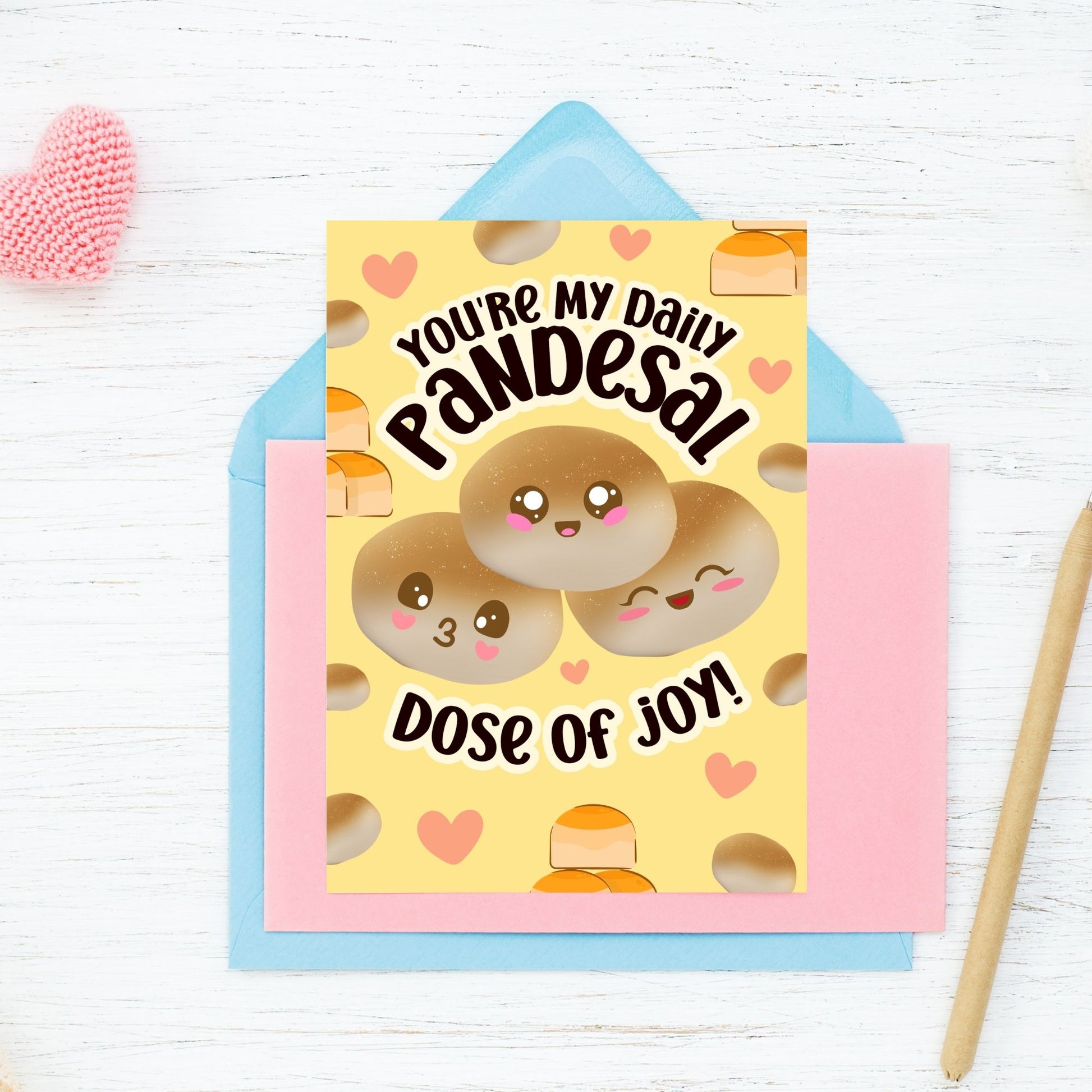 Printable Valentine’s Day card featuring the phrase “You’re My Daily Pandesal Dose of Joy” with a cute and warm pandesal design. Designed as a 5x7 PDF on an 8.5 x 11 sheet with two cards per page. A punny and heartfelt Valentine’s card for Filipino food lovers.