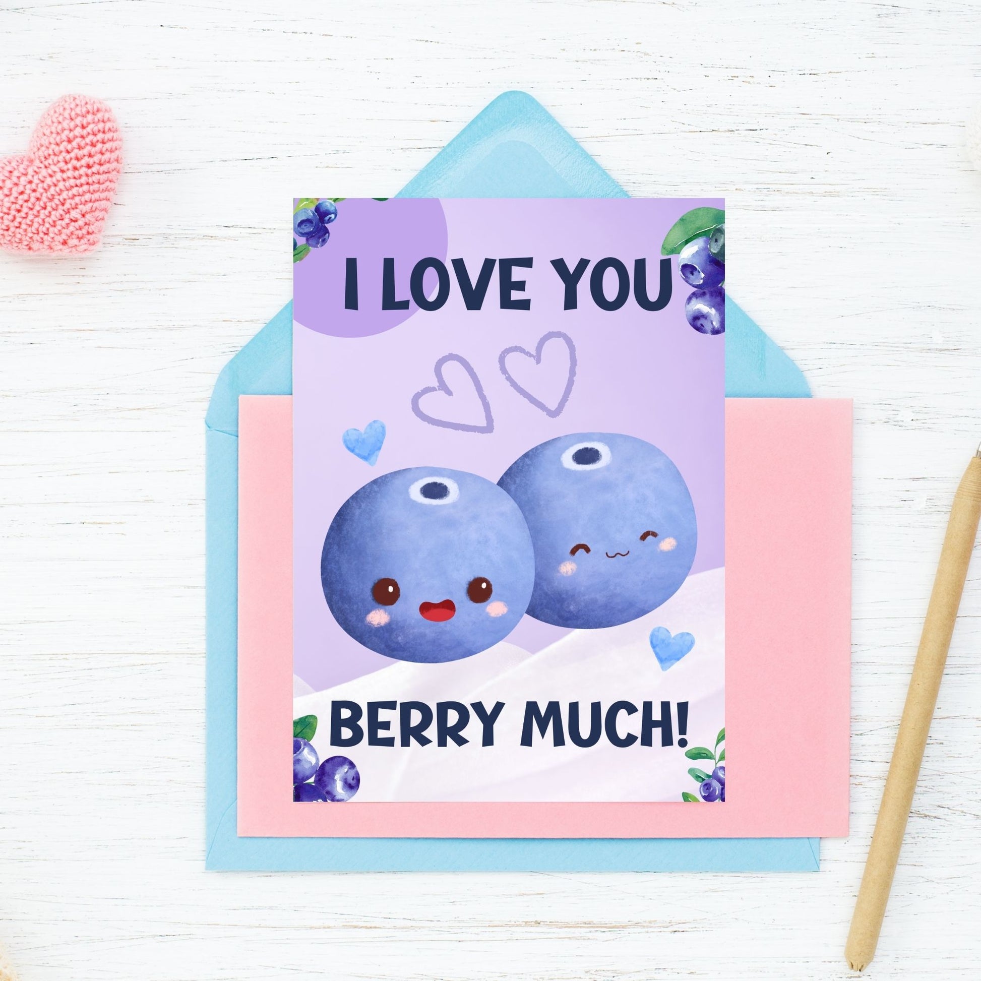 Printable Valentine’s Day Greeting Card featuring the phrase “I Love You Berry Much” with a blueberry theme. Designed as a 5x7 PDF on an 8.5 x 11 sheet with two cards per page. A sweet and punny Valentine’s card for loved ones.