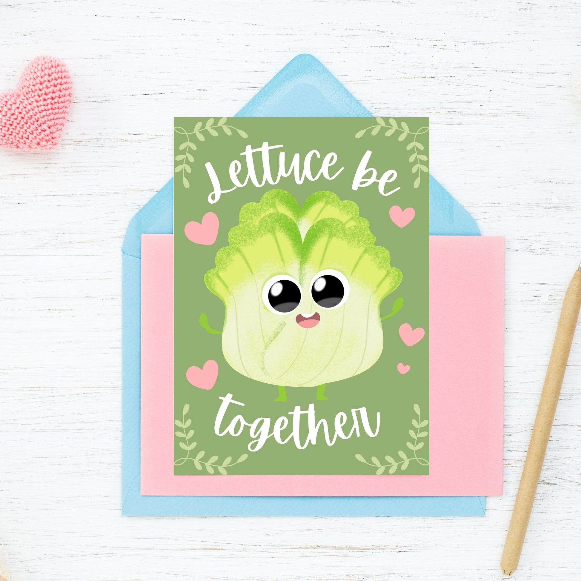 Printable Valentine’s Day Greeting Card featuring the phrase “Lettuce Be Together” with a fun lettuce design. Designed as a 5x7 PDF on an 8.5 x 11 sheet with two cards per page. A punny and fresh Valentine’s card for loved ones.