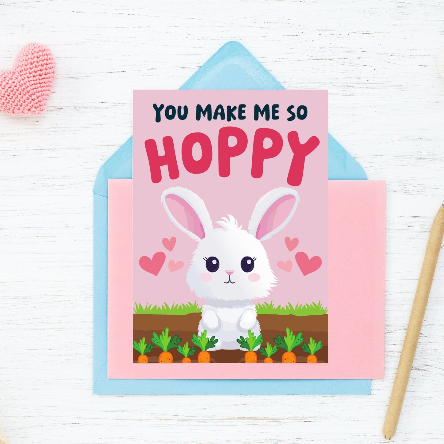 Printable Valentine’s Day Greeting Card featuring the pun “You Make Me So Hoppy.” Designed as a 5x7 PDF on an 8.5 x 11 sheet with two cards per page. A fun and cute Valentine’s card for bunny lovers.