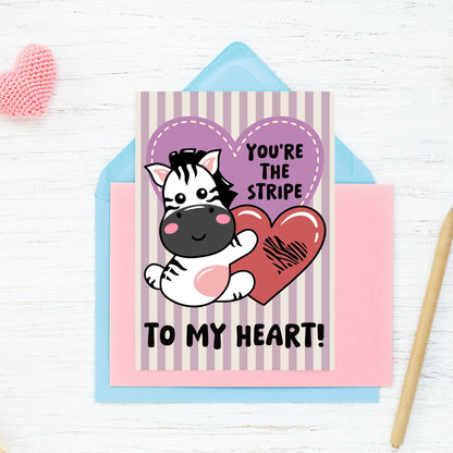 Printable Valentine’s Day Greeting Card featuring the phrase “You’re the Stripe to My Heart” with a zebra design. Designed as a 5x7 PDF on an 8.5 x 11 sheet with two cards per page. A cute and heartfelt Valentine’s card for zebra lovers.