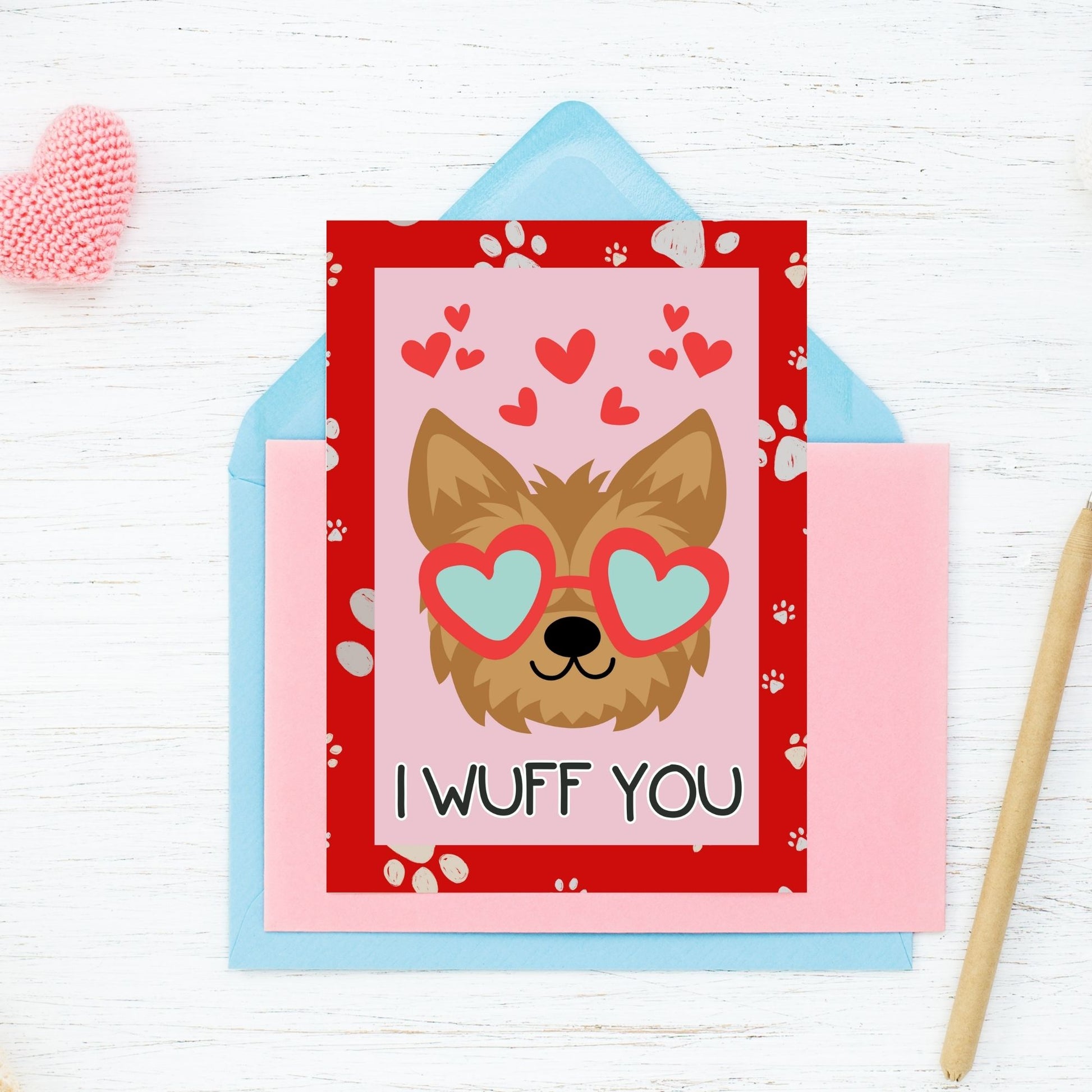 Printable Valentine’s Day Greeting Card featuring the pun “I Wuff You.” Designed as a 5x7 PDF on an 8.5 x 11 sheet with two cards per page. A cute and fun Valentine’s card for dog lovers.