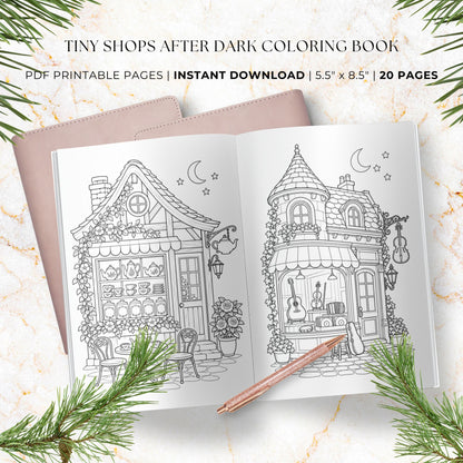 A styled flat-lay of a coloring book cover and an open preview page showing black-and-white shop illustrations, with text reading 'TINY SHOPS AFTER DARK COLORING BOOK' and 'PDF PRINTABLE PAGES | INSTANT DOWNLOAD | 5.5" x 8.