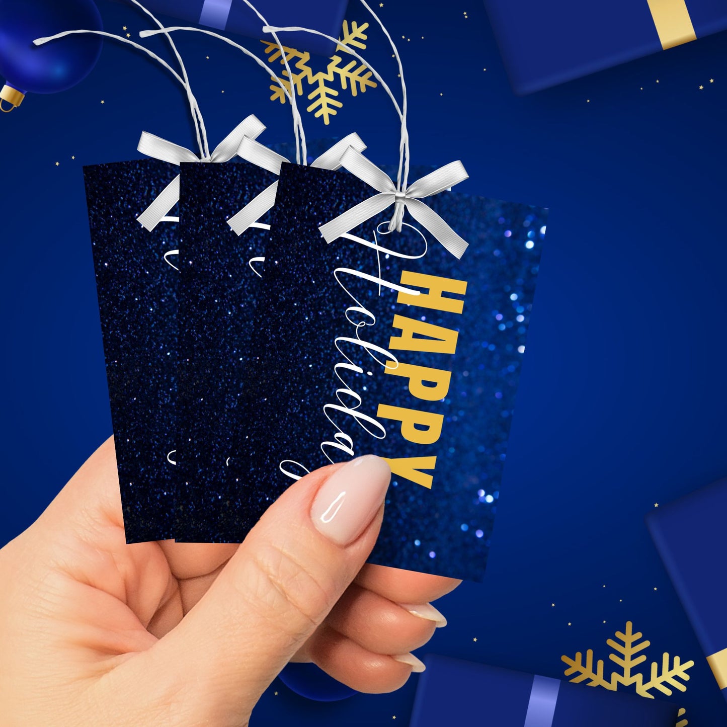 Printable blue and gold Holiday gift tags featuring a sparkling blue glitter background and bold gold "Happy Holidays" text, sized 2.5 x 3.5 inches, 8 per sheet.