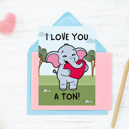 Printable Valentine’s Day Greeting Card featuring the phrase “I Love You a Ton” with an elephant theme. Designed as a 5x7 PDF on an 8.5 x 11 sheet with two cards per page. A cute and heartfelt Valentine’s card for loved ones.