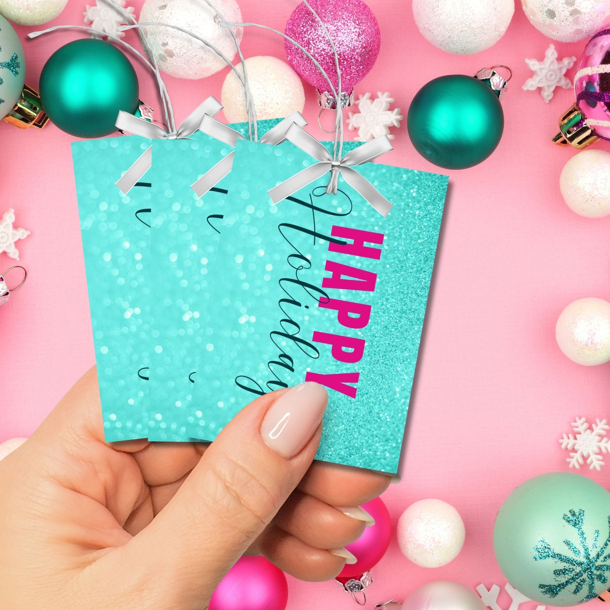 Printable Holiday gift tags featuring an aqua glitter background with bold magenta "Happy Holidays" text and black script accents, sized 2.5 x 3.5 inches, 8 tags per sheet.