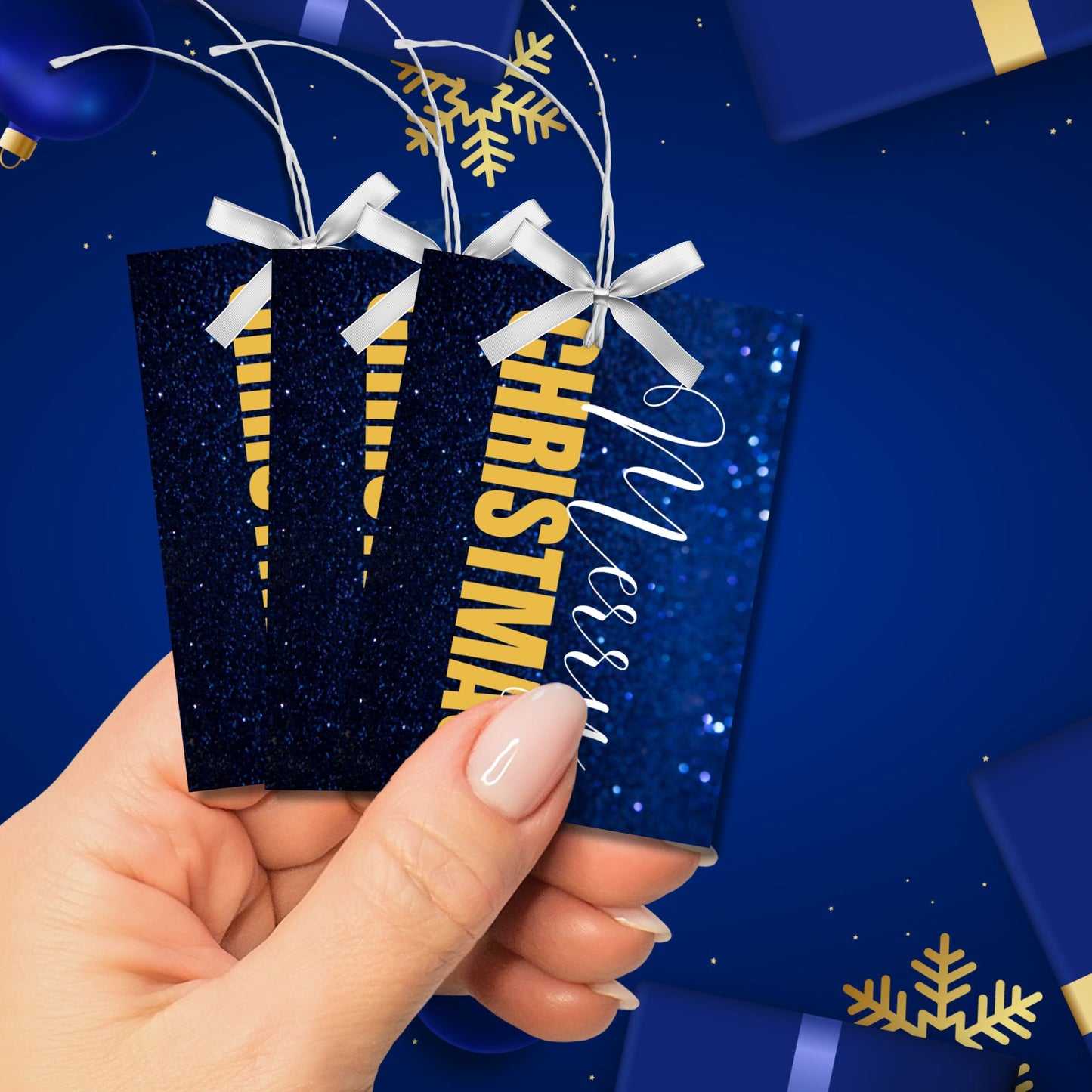 Printable blue and gold Christmas gift tags featuring a sparkling blue glitter background and bold gold "Merry Christmas" text, sized 2.5 x 3.5 inches, 8 per sheet.