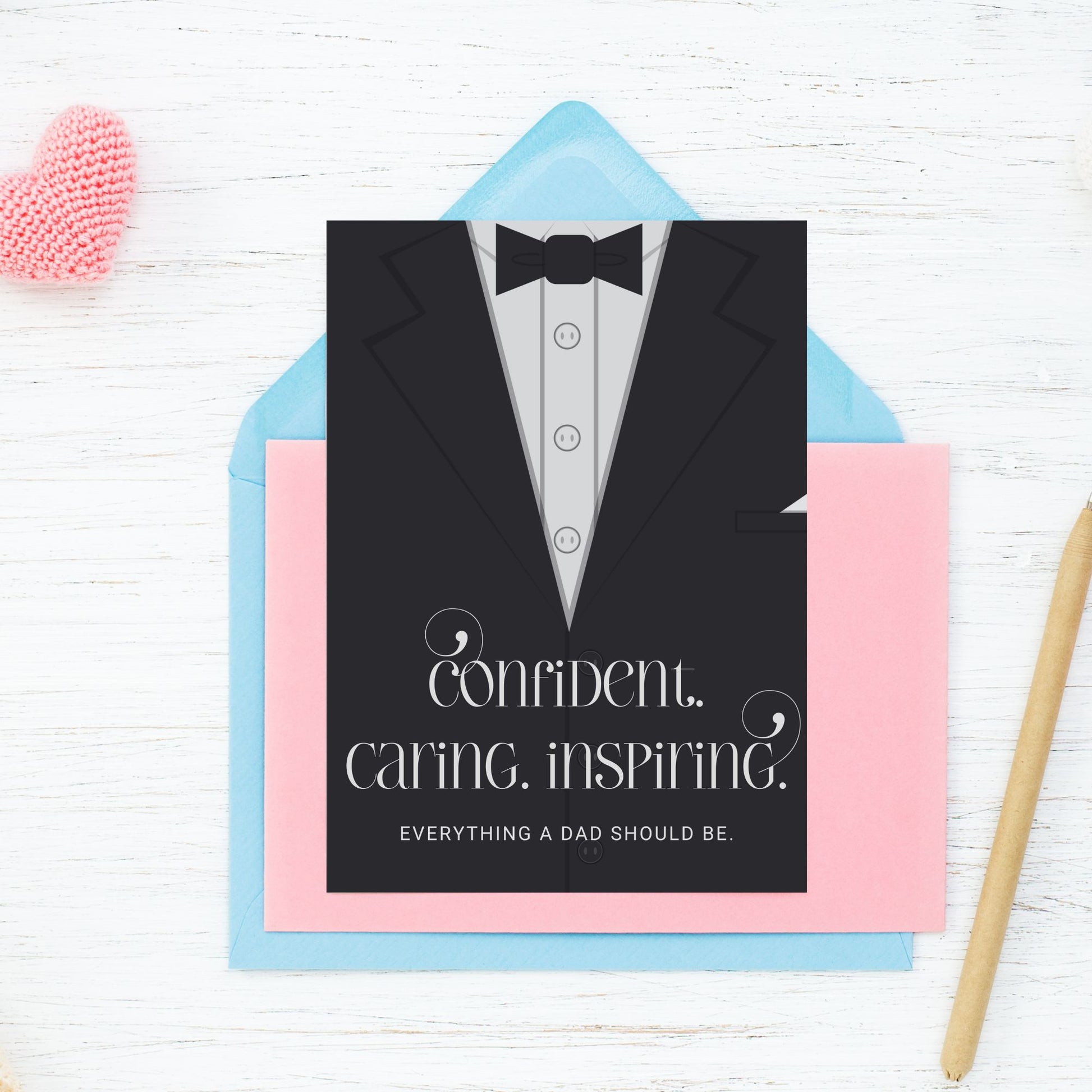 Father's Day card printable with bold text 'Confident. Caring. Inspiring.' featuring a minimalist design of a suit and tie in grayscale tones.
