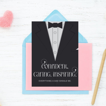 Father's Day card printable with bold text 'Confident. Caring. Inspiring.' featuring a minimalist design of a suit and tie in grayscale tones.