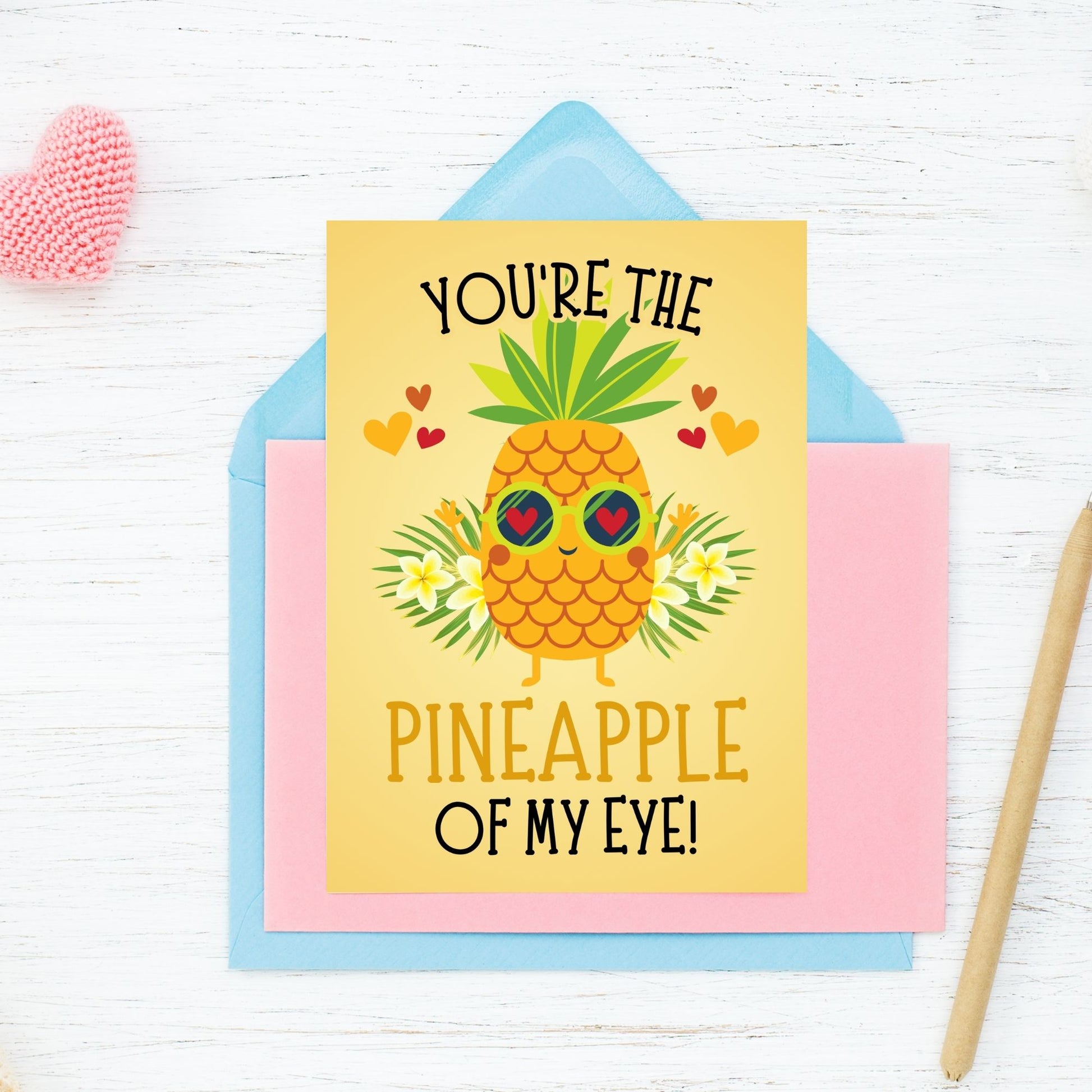 Printable Valentine’s Day Greeting Card featuring the phrase “You’re the Pineapple of My Eye” with a cheerful pineapple theme. Designed as a 5x7 PDF on an 8.5 x 11 sheet with two cards per page. A fun and tropical Valentine’s card for loved ones.