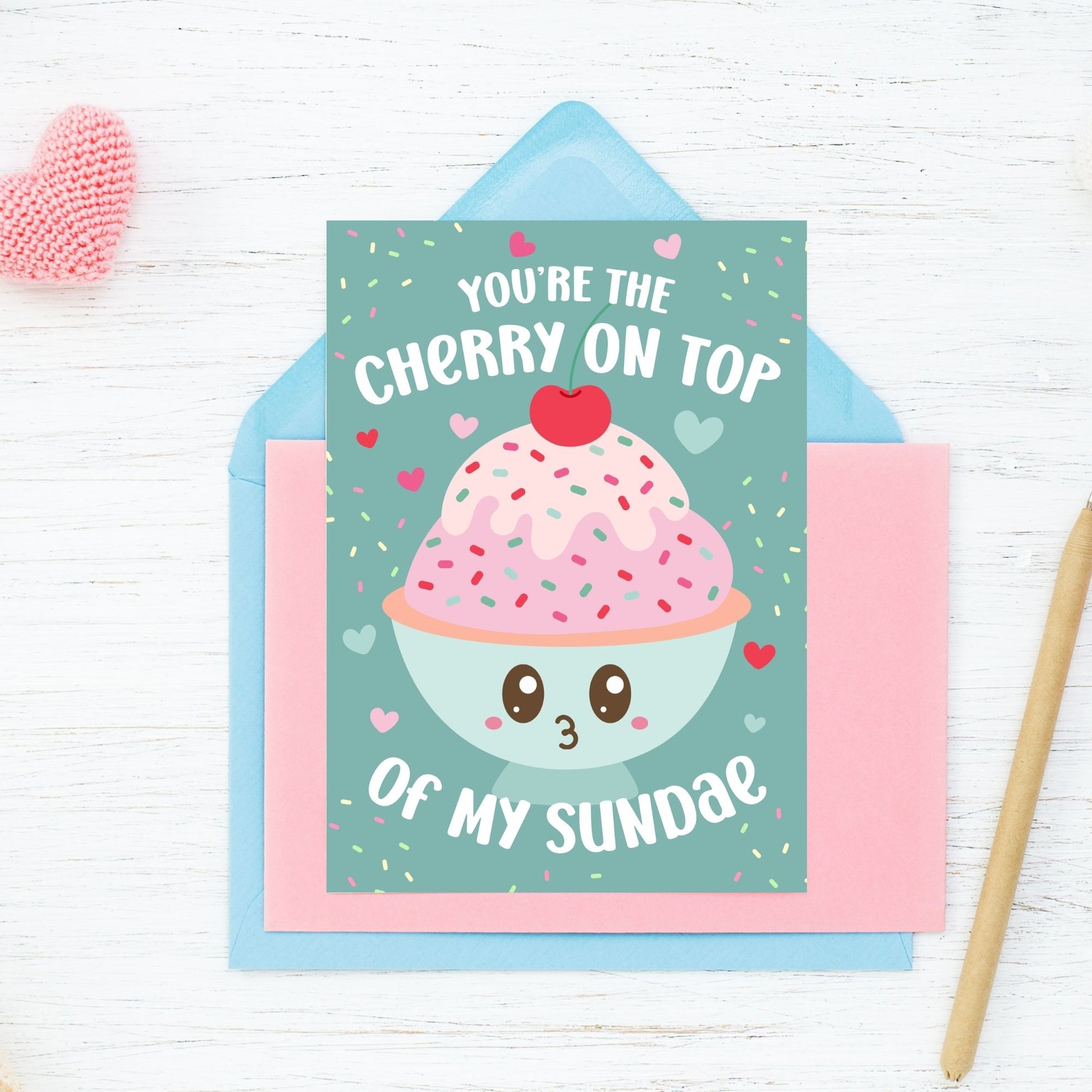 Printable Valentine’s Day card featuring the phrase “You’re the Cherry on Top of My Sundae” with a cute ice cream sundae design. Designed as a 5x7 PDF on an 8.5 x 11 sheet with two cards per page. A punny and heartfelt Valentine’s card for loved ones.