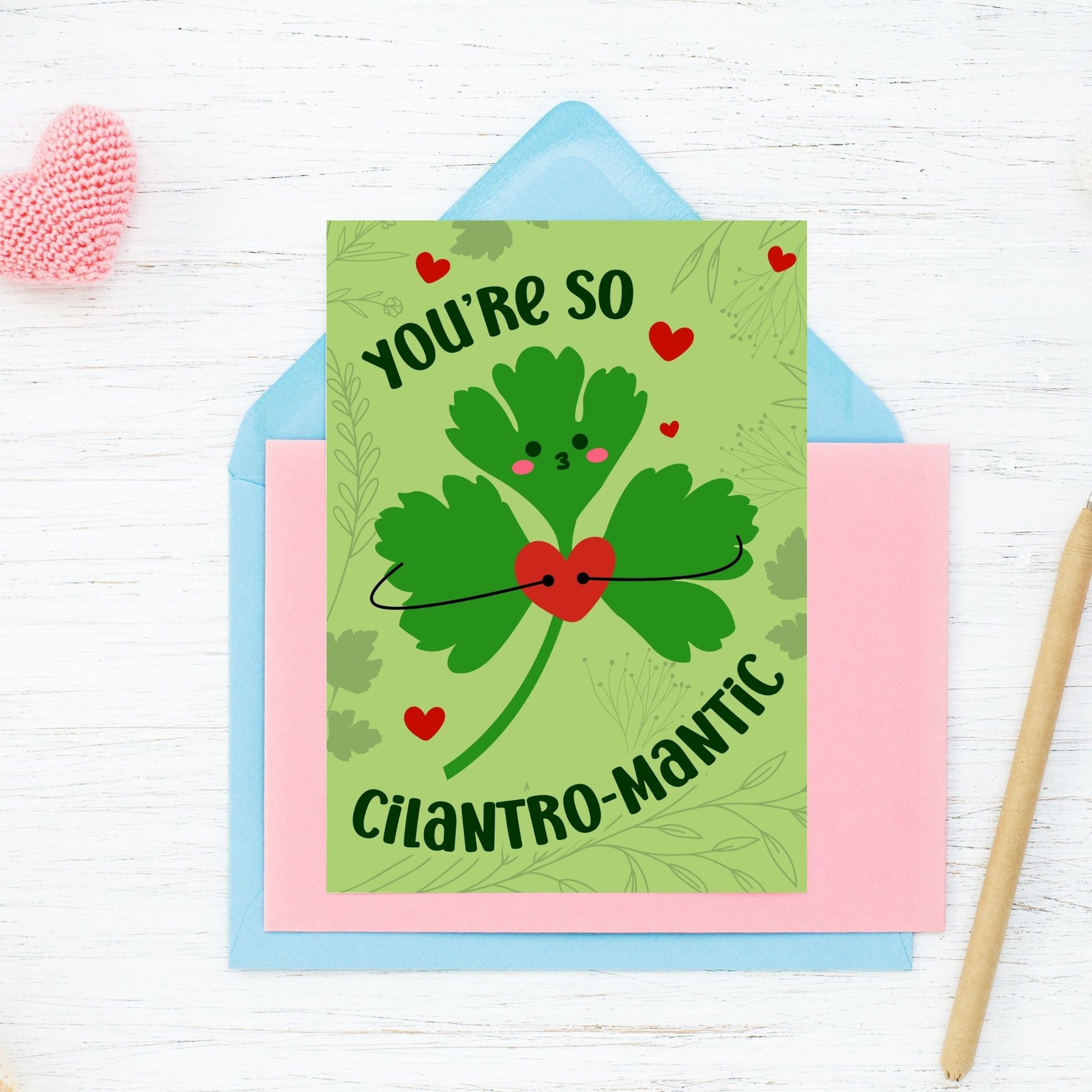 Printable Valentine’s Day Greeting Card featuring the phrase “You’re So Cilantromantic” with a playful cilantro design. Designed as a 5x7 PDF on an 8.5 x 11 sheet with two cards per page. A punny and romantic Valentine’s card for loved ones.