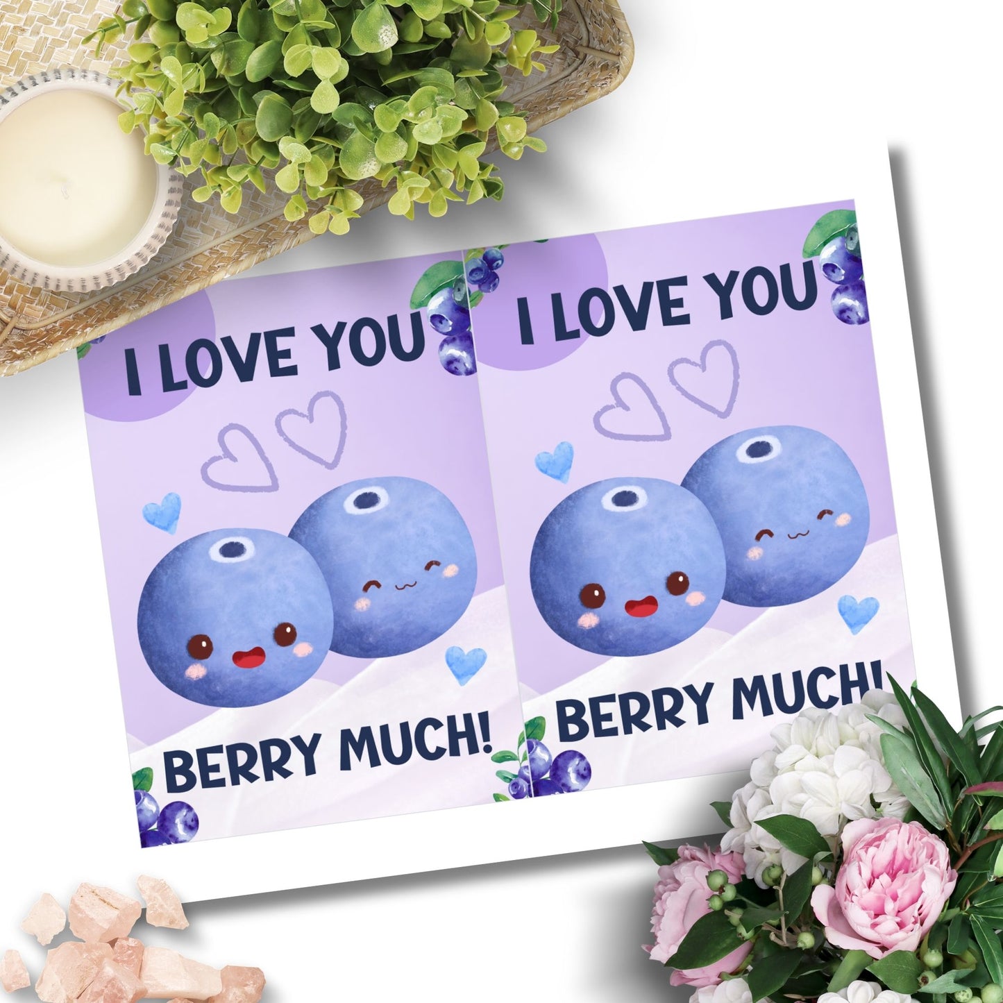 Printable Valentine’s Day Greeting Card featuring the phrase “I Love You Berry Much” with a blueberry theme. Designed as a 5x7 PDF on an 8.5 x 11 sheet with two cards per page. A sweet and punny Valentine’s card for loved ones.