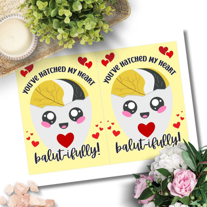 Printable Valentine’s Day card featuring the phrase “You’ve Hatched My Heart Balutifully” with a fun and unique balut (Filipino delicacy) design. Designed as a 5x7 PDF on an 8.5 x 11 sheet with two cards per page. A punny and heartfelt Valentine’s card for Filipino food lovers.