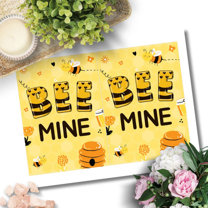 Printable Valentine’s Day Greeting Card featuring the phrase “Bee Mine.” Designed as a 5x7 PDF on an 8.5 x 11 sheet with two cards per page. A cute and charming Valentine’s card for bee lovers.