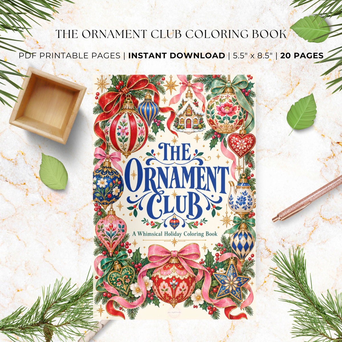 The Ornament Club Coloring Book cover displayed on a light marble surface with holiday-themed flat-lay props including pine branches, green leaves, a small wooden tray, and a pencil. Text at the top reads 'The Ornament Club Coloring Book' and 'PDF Printable Pages | Instant Download | 5.