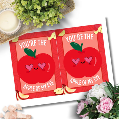 Printable Valentine’s Day Greeting Card featuring the phrase “You’re the Apple of My Eye” with an apple design. Designed as a 5x7 PDF on an 8.5 x 11 sheet with two cards per page. A sweet and timeless Valentine’s card for loved ones.