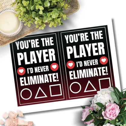 Squid Game-inspired Valentine’s Day card with a player selection theme, perfect for fans. Features bold red, black, and white colors with a playful elimination message.